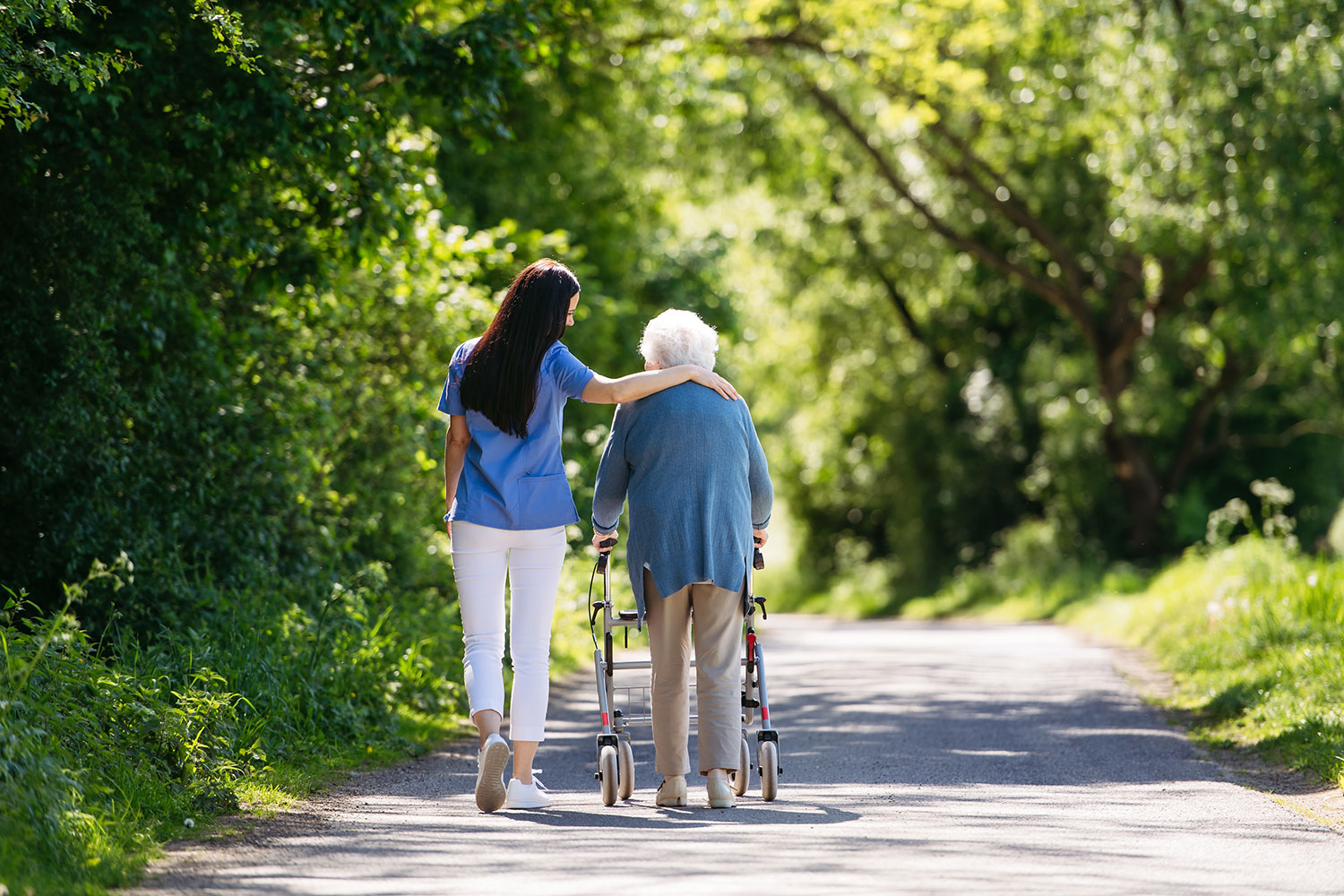 caregiver with memory care patient out for a walk after learning practical tips for Alzheimer's care